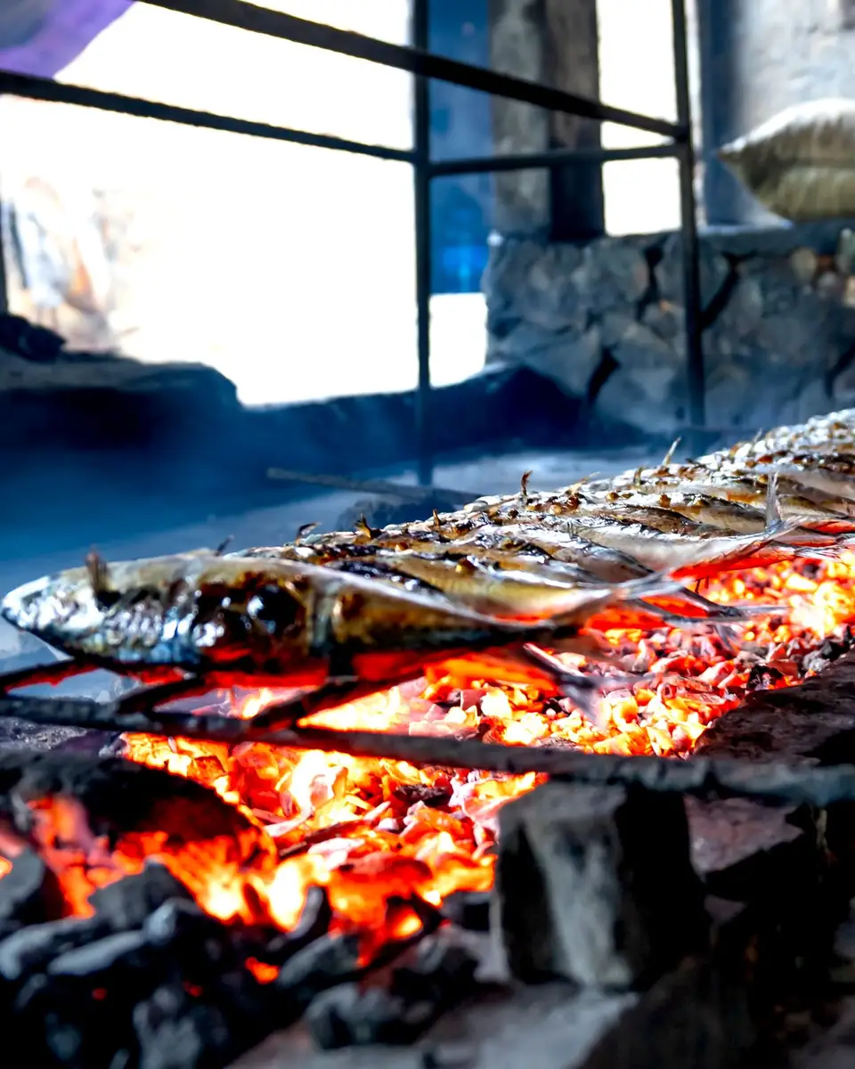 Fish grilling over a charcoal fire.